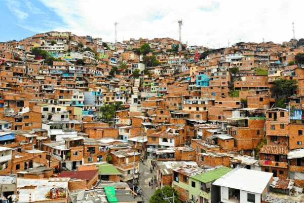 Medellin Comuna 13 Tour  showing colorful houses and street art murals.