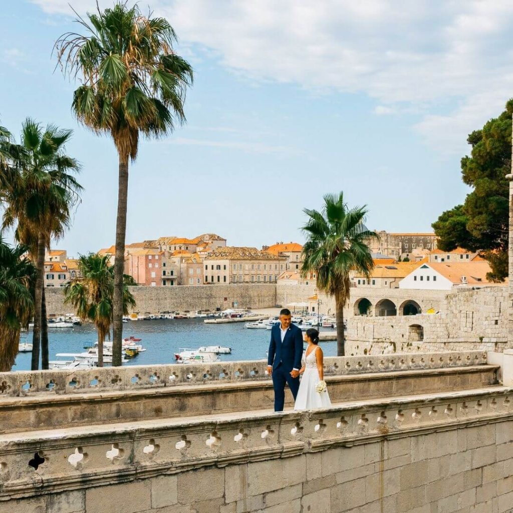 Colombian-Croatian couple walking in Dubrovnik during their wedding – founders of Medellin Insider