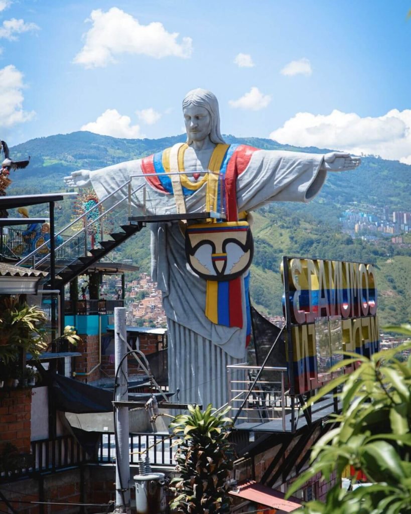 Cristo de la Comuna statue in Comuna 13 Medellin wearing Colombian colors