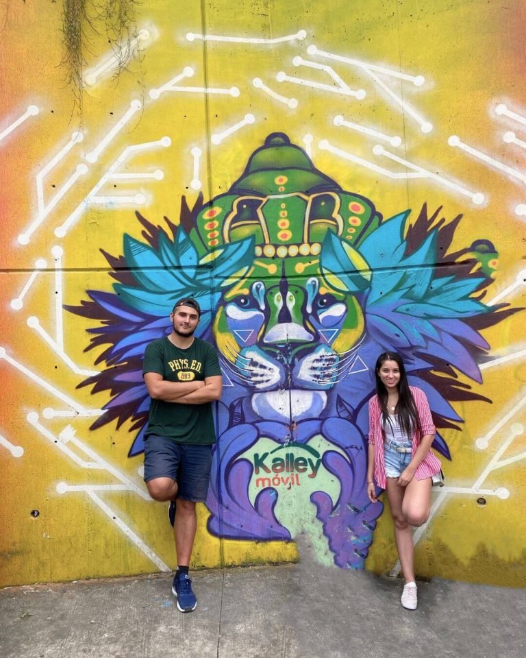 Founders of Medellin Insider posing with a lion graffiti mural in Comuna 13 Medellin
