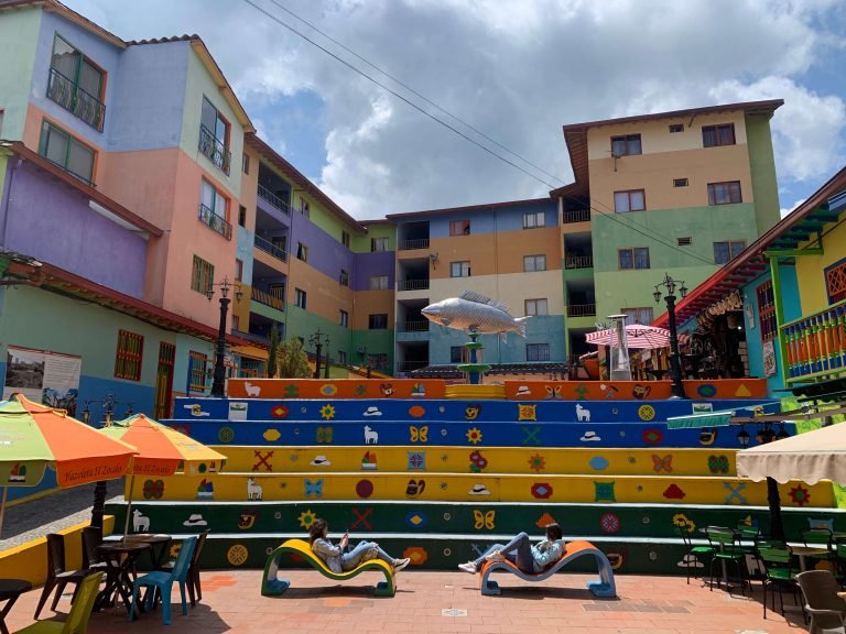 Colorful stairs at Plaza del Zócalo in Guatape, surrounded by zócalo-painted buildings and cafés